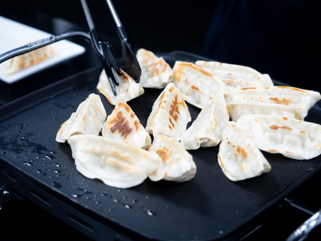 Frying gyozas in a pan