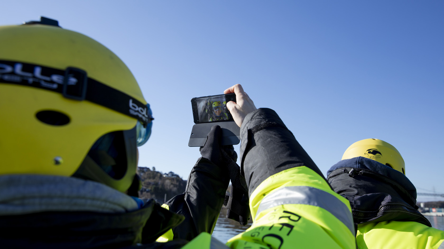 Person with a helmet taking a selfie on a rib boat